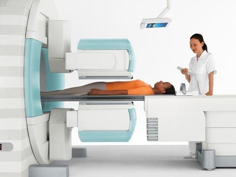 Technologist positioning a patient for a CT scan